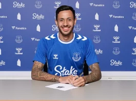 Dwight McNeil poses as he signs for Everton