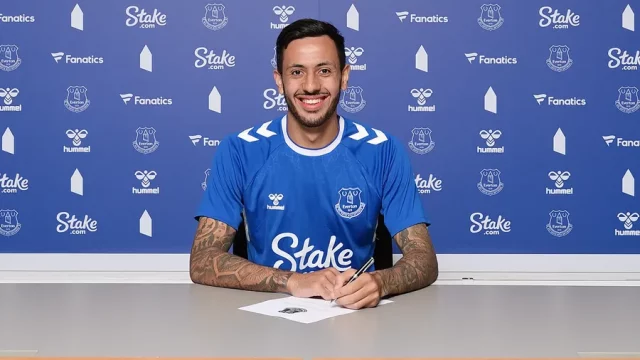 Dwight McNeil poses as he signs for Everton