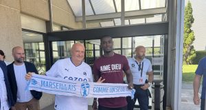 Eric Bailly pictured with a Marseille scarf as he completes a move to the French club from Manchester United