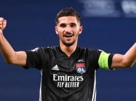 Houssem Aouar celebrates with a smile and his hands up in the air