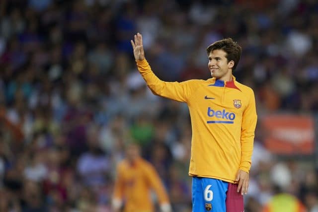 Riqui Puig smiles in a Barcelona jersey