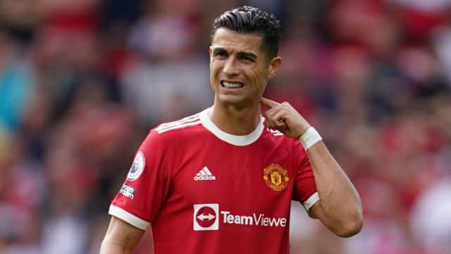 Cristiano Ronaldo grimaces in a Manchester United jersey